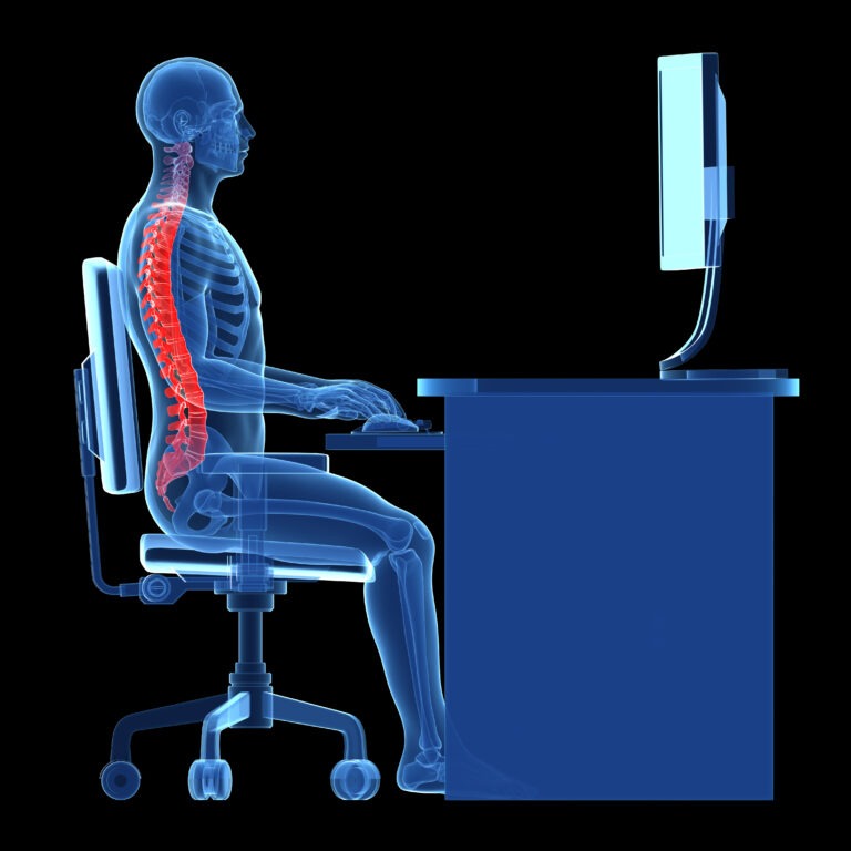 A side view of a transparent human figure sitting at a desk, highlighting the spine in red, illustrating posture and potential ergonomic issues.